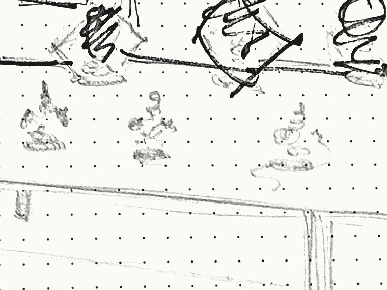 Detail of the storyboard: small clay figures standing on the table surface.